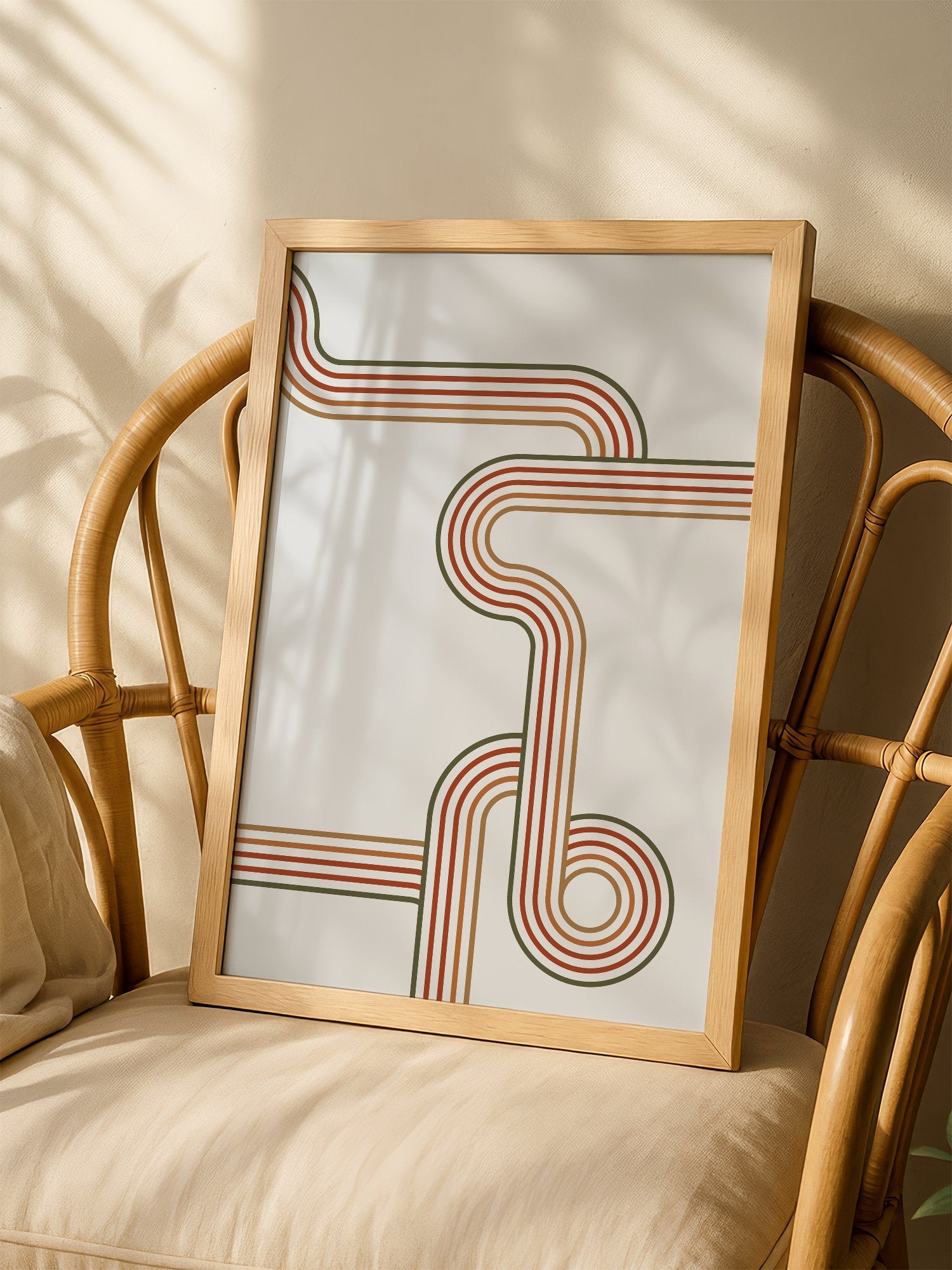 Abstract geometric wall art with flowing curved parallel lines in rust red, shown in minimalist home office space