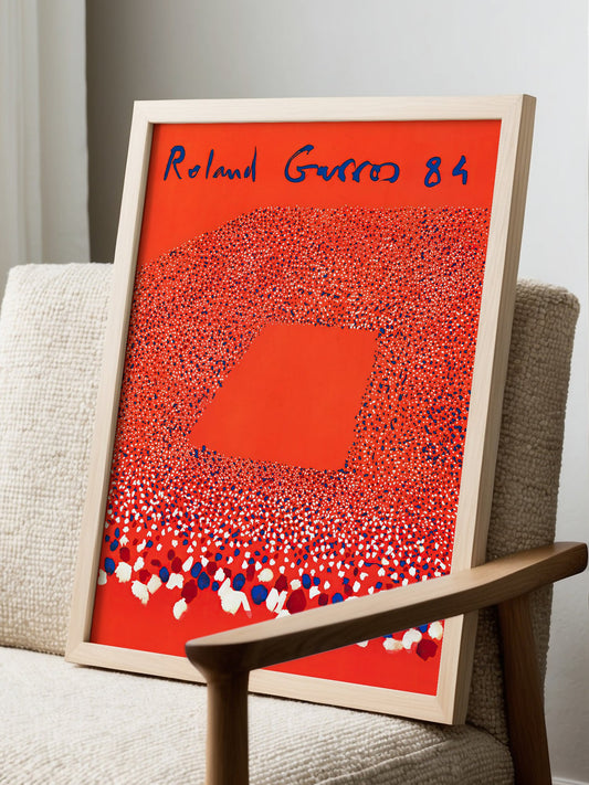 Roland Garros 84 French Open tennis poster featuring burnt orange background, displayed in modern living room setting